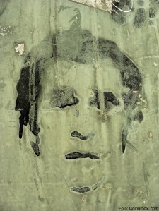Grunge face a man graffiti style artist on green metal